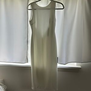 White firm fitting midi dress with low back and modest neckline.